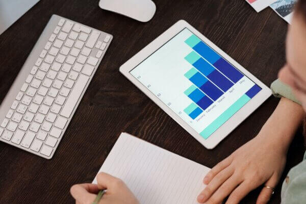 photo of chart going up and to the right on a tablet with a keyboard nearby