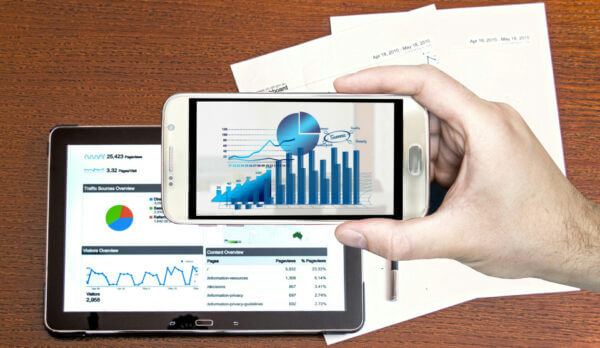 charts on phone and computer with printouts