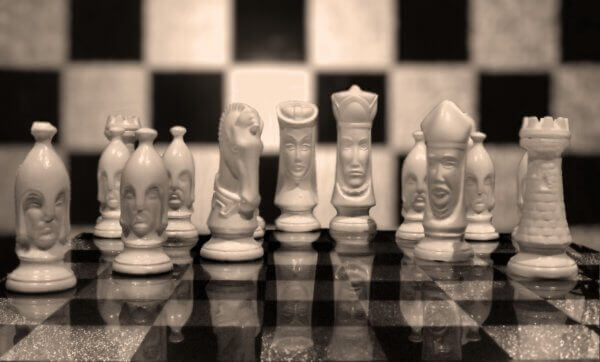 photo of a chessboard whose pieces have faces