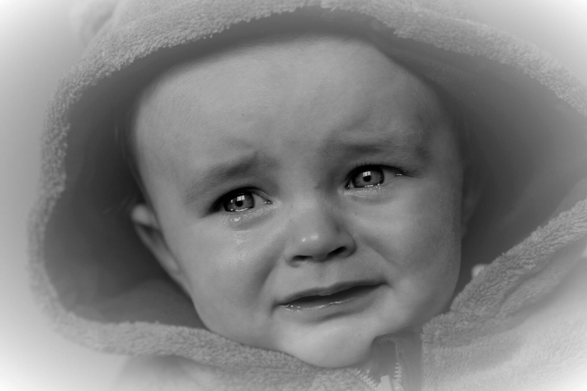 photo of a teary-eyed baby