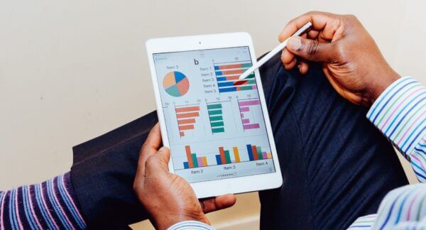 photo of a tablet with various charts and graphs