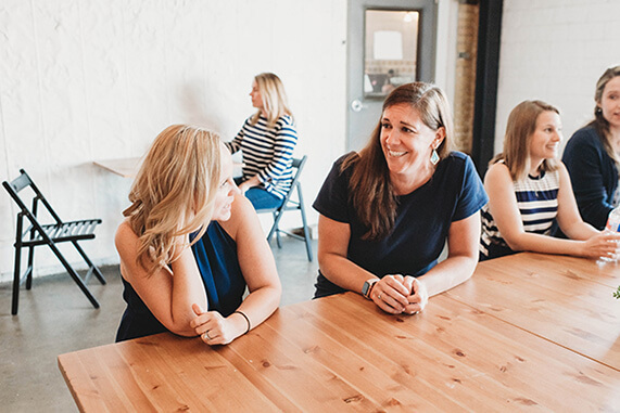 team members jeanne, barbara, shayna, christina, and annie sitting and talking